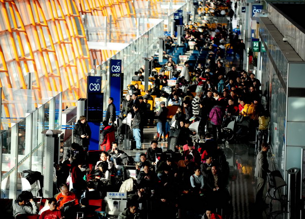 Many passengers are stuck in the Beijing Capital International Airport on Sunday after flights to snowstorm-hit Shenyang, capital of Liaoning province, are canceled. [Photo/provided to China Daily]