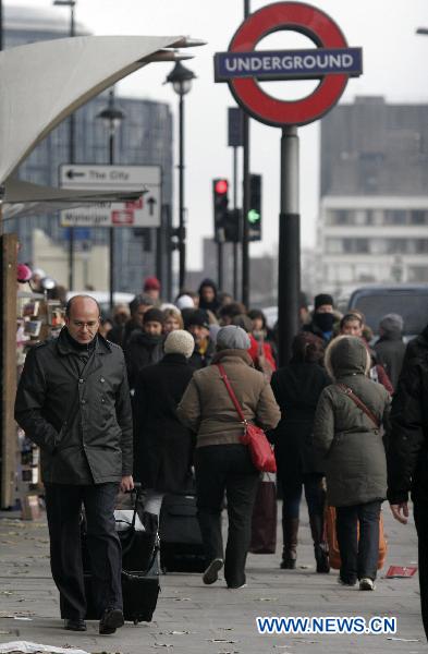 Pedestrians walk past a sign of tube station in London, capital of Britain, Nov. 29, 2010. Passengers on the London Underground network are enduring disruption to their journeys as thousands of members of the Transport Salaried Staffs Association (TSSA) and the Rail, Maritime and Transport Union (RMT) stage a 24-hour strike to protest planned job cuts from Sunday evening, the fourth 24-hour strike on London tube system since August. [Bimal Gautam/Xinhua]