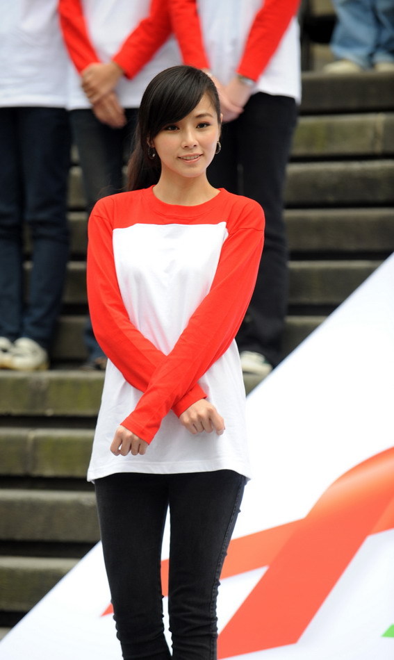 Actress Tammy Chen poses to form the shape of a red ribbon in front of a museum during an activity in Taipei, southeast China&apos;s Taiwan, on Nov. 30, 2010, a day ahead of the World AIDS Day. [Xinhua]