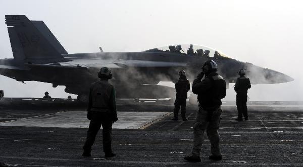 A jet fighter is about to take off from the aircraft carrier USS George Washington during a joint military exercise conducted by South Korea and the United States in tense waters west of the divided Korean Peninsula on Nov. 30, 2010. [Xinhua]
