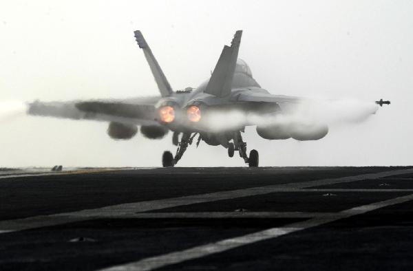 A jet fighter takes off from the aircraft carrier USS George Washington during a joint military exercise conducted by South Korea and the United States in tense waters west of the divided Korean Peninsula on Nov. 30, 2010.[Pool/Xinhua]
