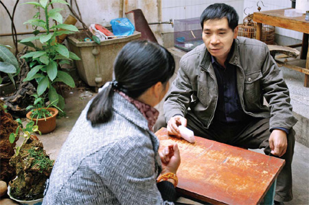An employee with the local center for disease control tells an HIV-infected patient (left) how to take her medicine on Nov 25 in Yuxi's Hongta district, Yunnan province. Hongta's anti-AIDS workers have spent eight years trying to reach out to sex workers in an effort to educate them in the benefits of safe sex. 
