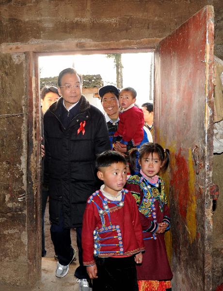 Chinese Premier Wen Jiabao (L) visits the residence of AIDS patients in Butuo County of Liangshan Yi Autonomous Prefecture, southwest China&apos;s Sichuan Province, Dec.1, 2010. Visiting poverty-stricken area, Wen urged a better incorporation of AIDS control work with economic development in less developed areas. [Xinhua] 