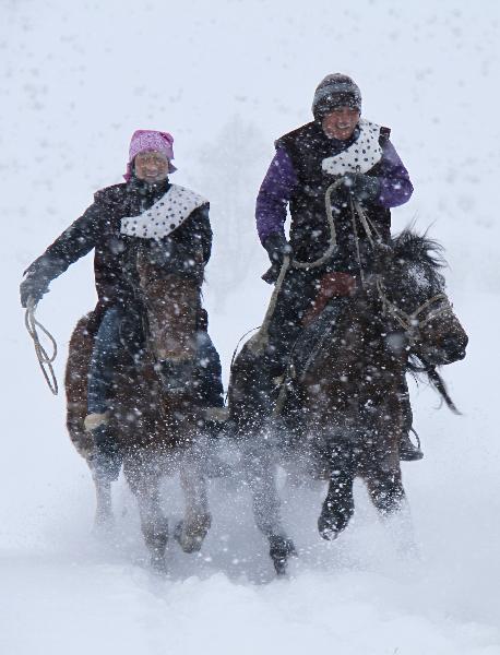 People of China's Kazak ethnic group ride horses in the snow in Altay City of northwest China's Xinjiang Uygur Autonomous Region, Nov. 30, 2010. Altay City is an attractive tourism destination for domestic people interested in winter traveling. (Xinhua/Tang Xiaobo) 