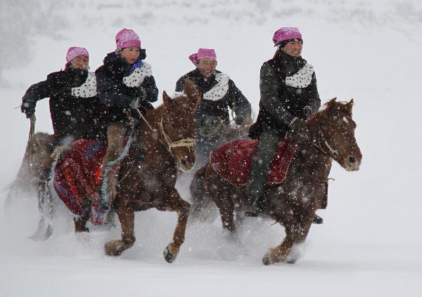 People of China's Kazak ethnic group ride horses in the snow in Altay City of northwest China's Xinjiang Uygur Autonomous Region, Nov. 30, 2010. Altay City is an attractive tourism destination for domestic people interested in winter traveling. [Xinhua/Tang Xiaobo]