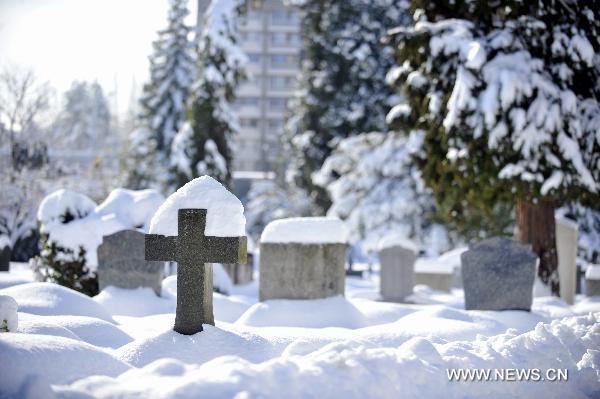 Snow covers the gravestones in Geneva, Switzerland, Dec. 2, 2010. Weather turned fine in Geneva on Thursday after the continuous snowfall. [Xinhua]