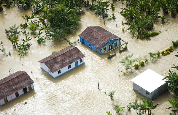 This image provided by the Venezuelan Government shows an aerial view of flooded areas in Barlovento, Miranda State, Venezuela, on Dec. 2, 2010. Weeks of downpours in Venezuela that have caused flooding and mudslides has killed more than twenty people and forced thousands to flee from their home, authorities said. [Xinhua/Venezuelan Government] 