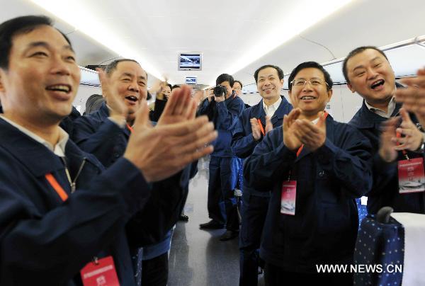 Technicians applaud in the train CRH380A of China Railway High-Speed (CRH), which runs between the north China&apos;s Zaozhuang city and Bengbu in the south, a segment of the Beijing-Shanghai high-speed rail line, Dec. 3, 2010. China&apos;s high-speed train CRH380A hit a maximum speed of 486.1 kilometers per hour on Friday during its trial service, which broke a world operation speed record. [Xinhua]