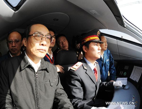 Liu Zhijun (L front), minister of China&apos;s Ministry of Railways, monitors the train CRH380A of China Railway High-Speed (CRH), which runs between the north China&apos;s Zaozhuang city and Bengbu in the south, a segment of the Beijing-Shanghai high-speed rail line, Dec. 3, 2010. China&apos;s high-speed train CRH380A hit a maximum speed of 486.1 kilometers per hour on Friday during its trial service, which broke a world operation speed record. [Xinhua]