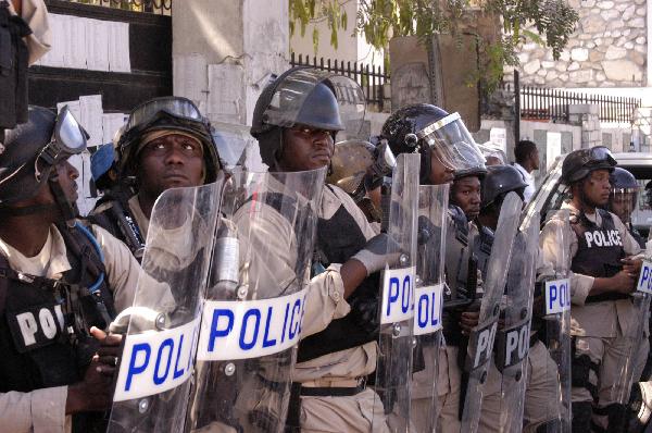 Policemen guard during a protest that around 2,000 Haitians marched demanding a rerun of Sunday&apos;s elections, in Port-au-Prince, Haiti&apos;s capital, on Dec. 2, 2010. [Xinhua]