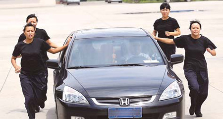 Four female bodyguards train in Chengdu, Sichuan province, prior to the Beijing Olympic Games in this file photo taken in July 2008. They were among 300 bodyguards hired by a security company to ensure the safety of VIPs during the Games. 