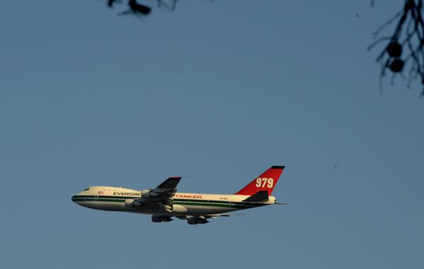 U.S Evergreen supertanker, the world&apos;s largest flying fire extinguisher, a Boeing 747 extinguishes fire near Isfiya, on Mount Carmel, near Haifa, north Israel, Dec. 5, 2010. After more than three days&apos; arduous battle, Israeli firefighting authority announced Sunday afternoon that it had fully contained the inferno, according to local news service Ynet. [Xinhua]