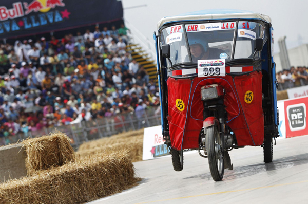 A three-wheeled taxi vehicle, or &apos;mototaxi&apos;, negotiates the course during a race against the clock on the outskirts of Lima, Peru Dec 5, 2010. [China Daily/Agencies]