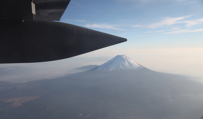 A C-130H Hercules transport aircraft fly near the Fuji Mountain during a joint military drill in Japan, Dec. 6, 2010. Japan and the United States launched their a joint military exercise on Dec. 3. [Xinhua]