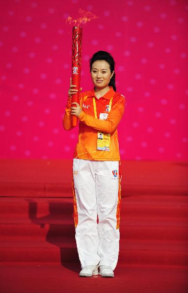 Torchbearer Nan Xin relays the torch during the torch relay for the Guangzhou 2010 Asian Para Games in Guangzhou, south China's Guangdong Province, Dec. 6, 2010. (Xinhua/Liang Xu) 