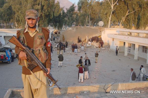 A security member guards at the site of a suicide bombing in northwest Pakistan's Mohmand region on December 6, 2010. Two suicide bombers Monday targeted a meeting of pro-government tribal elders in a Pakistani tribal region, killing at least 50 people with 120 others injured.