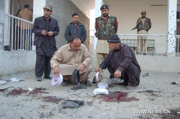 Security personnel check the site of a suicide bombing in northwest Pakistan's Mohmand region on December 6, 2010. Two suicide bombers Monday targeted a meeting of pro-government tribal elders in a Pakistani tribal region, killing at least 50 people with 120 others injured.