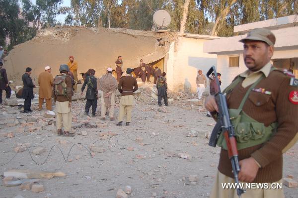 A security member guards at the site of a suicide bombing in northwest Pakistan's Mohmand region on December 6, 2010. Two suicide bombers Monday targeted a meeting of pro-government tribal elders in a Pakistani tribal region, killing at least 50 people with 120 others injured. 