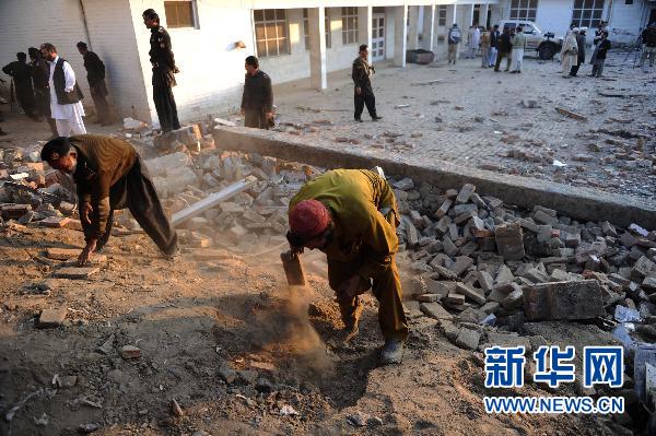 People clear the rubble at the site of a suicide bombing in northwest Pakistan's Mohmand region on December 6, 2010. Two suicide bombers Monday targeted a meeting of pro-government tribal elders in a Pakistani tribal region, killing at least 50 people with 120 others injured.