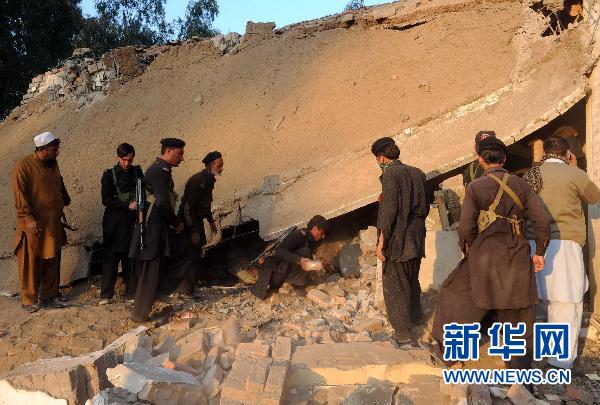 People clear the rubble at the site of a suicide bombing in northwest Pakistan's Mohmand region on December 6, 2010. Two suicide bombers Monday targeted a meeting of pro-government tribal elders in a Pakistani tribal region, killing at least 50 people with 120 others injured.