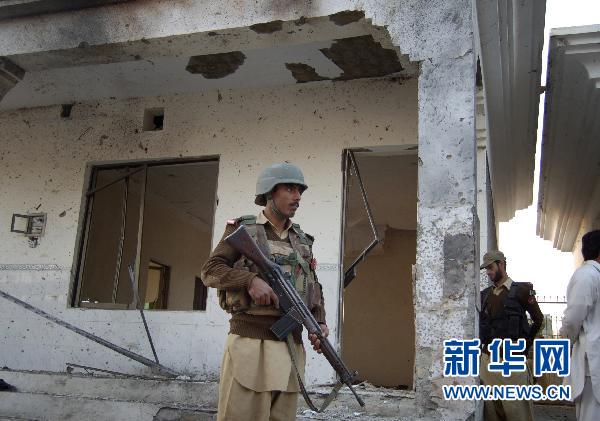 A security member guards at the site of a suicide bombing in northwest Pakistan's Mohmand region on December 6, 2010. Two suicide bombers Monday targeted a meeting of pro-government tribal elders in a Pakistani tribal region, killing at least 50 people with 120 others injured.