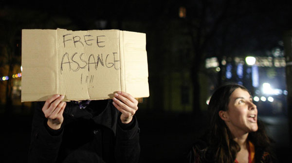 A protestor holds a banner in support of WikiLeaks founder Julian Assange during a flash mob demonstration, organised through the Internet, in front of the British Embassy in Sofia, Dec 7, 2010.