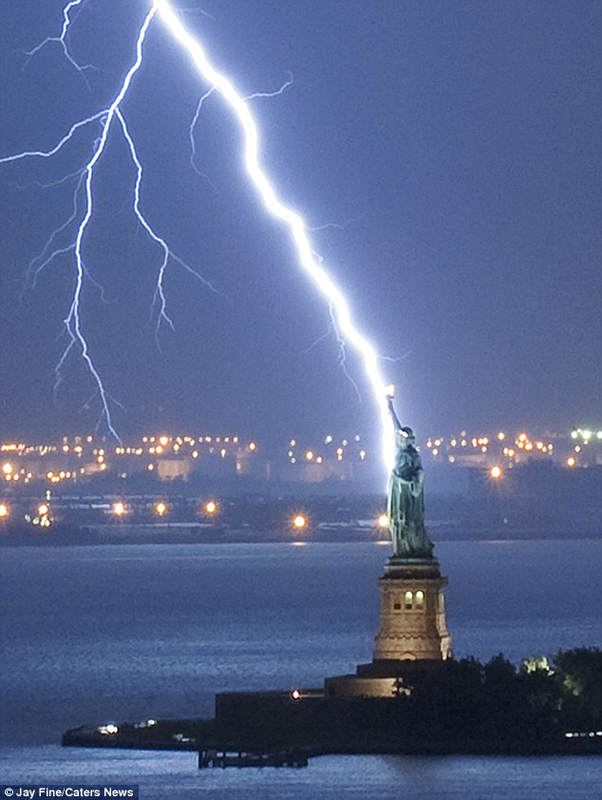 The photo taken at 8:45pm on September 22, 2010 shows lightning strikes the Statue of Liberty in New York harbour. [Agencies]