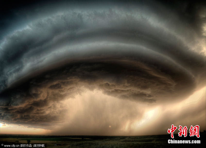 A super cell thunderstorm crosses a man&apos;s path and continues unabated across the plains on July 28, 2010, causing minimal damage as it does so, in Glasgow, Montana. [CFP]