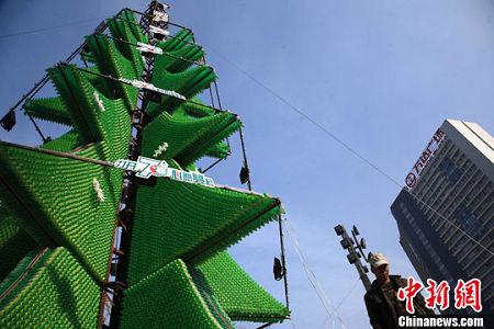 A 26-meter-high Christmas tree made up of 120,000 beverage bottles appears in front of a shopping mall in Chengdu, the capital of southwest China's Sichuan Province on Dec. 7. 