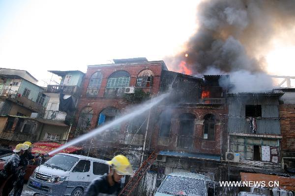 Fire fighters put out fire in residential apartments in Xiamen, southeast China&apos;s Fujian Province, Dec. 9, 2010. Fire broke out in the apartments at approximately 9:00 a.m. Thursday. Two people were confirmed dead by 10:00 am. The cause of the fire is still under investigation. [Xinhua] 