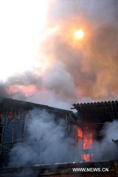 Heavy smoke cover the sun after a fire broke out in residential apartments in Xiamen, southeast China&apos;s Fujian Province, Dec. 9, 2010. Fire broke out in the apartments at approximately 9:00 a.m. Thursday. Two people were confirmed dead by 10:00 am. The cause of the fire is still under investigation. [Xinhua]