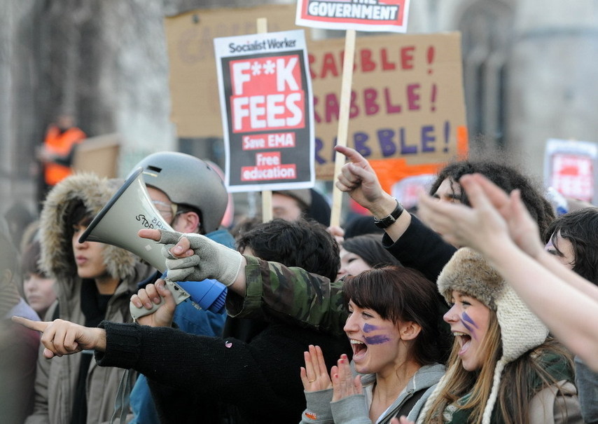 Over 20,000 students took to streets to protest against the coalition government&apos;s plan to raise the tuition fees cap in England from 3290 to 9,000 pounds per year, which was passed in the House of Commons Thursday, Dec. 9, 2010. More than a dozen of policemen and students have been injured during the clash. [Xinhua]