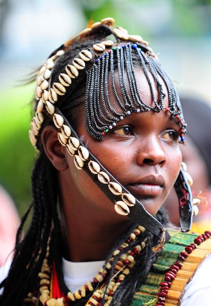 A girl from an aboriginal tribe in Eastern Province of Kenya wears a headgear made of shells on Dec. 7, 2010. 42 aboriginal tribes in Kenya share the cultural diversity with their different kinds of headgears made of fur, feather and shells. [Xinhua] 