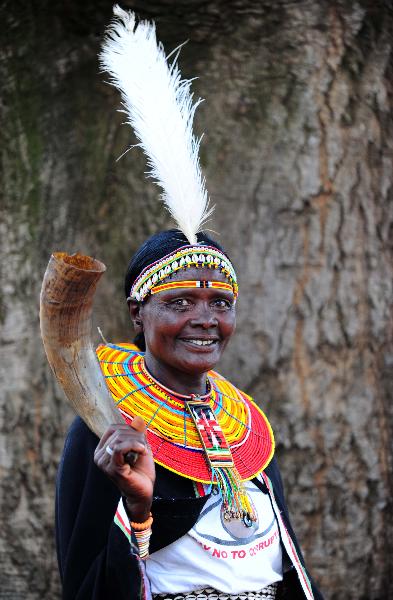 A woman from an aboriginal tribe in Eastern Province of Kenya wears a headgear made of feather on Dec. 7, 2010. 42 aboriginal tribes in Kenya share the cultural diversity with their different kinds of headgears made of fur, feather and shells. [Xinhua] 