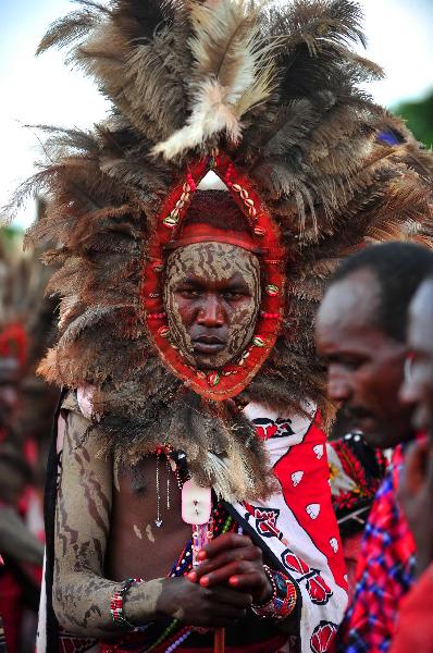 A Maasai man in Kenya wears a headgear made of feather on his Enkipaata Ritual on Aug. 22, 2010. 42 aboriginal tribes in Kenya share the cultural diversity with their different kinds of headgears made of fur, feather and shells. [Xinhua]