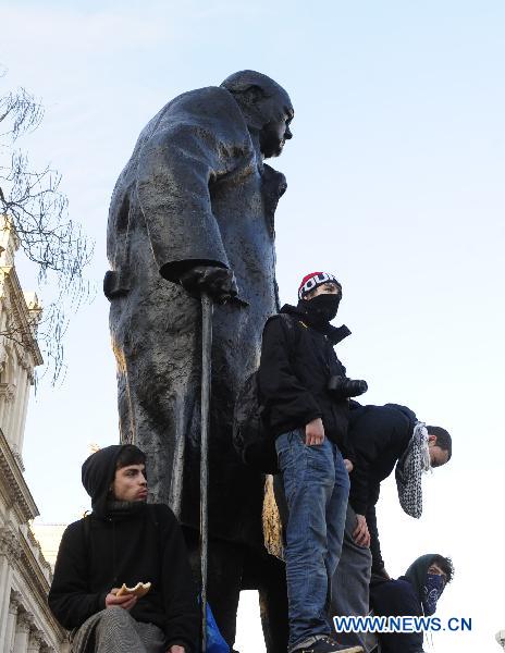 Protesters occupy the statue of Winston Churchill in front of the Parliament Building in London, Britain, Dec. 9, 2010. [Zeng Yi/Xinhua]