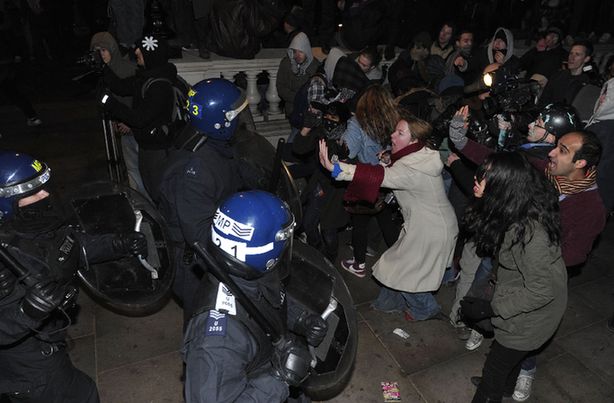 Police officers clash with students during protests against an increase in fees in central London, on December 9, 2010. Rioters battled police outside parliament and attacked a car carrying the heir to the throne Prince Charles as Britain's coalition survived a major test in a vote to raise university fees.[Xinhua] 