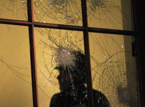 A police officer stands inside the Treasury building during a protest in Westminster, central London December 9, 2010.  