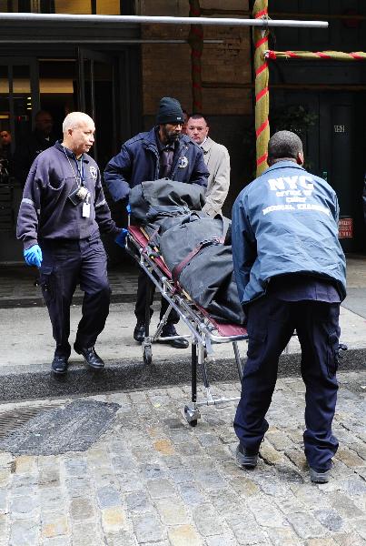 Members of the Office of the Chief Medical Examiner use a stretcher remove the body of Mark Madoff from the apartment building in which he lived in the Soho neighborhood of New York on Saturday, Dec. 11, 2010. [Xinhua/AFP]