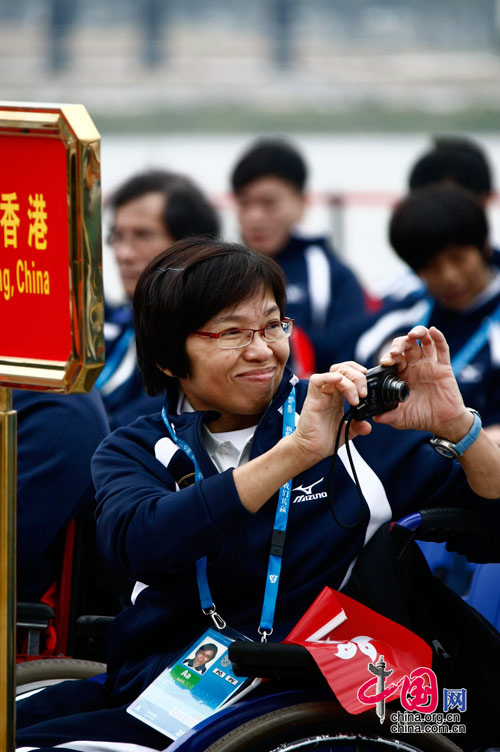 Members of China&apos;s Hong Kong delegation attend the national flag raising ceremony at the Athletes&apos; Village of the Guangzhou 2010 Asian Para Games in Guangzhou, capital of south China&apos;s Guangdong Province, Dec. 11, 2010. [Zhao Na/ China.org.cn]