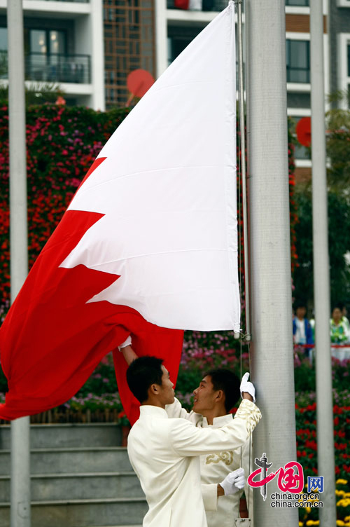 The national flag of Bahrain is raised at the Athletes&apos; Village of the Guangzhou 2010 Asian Para Games in Guangzhou, capital of south China&apos;s Guangdong Province, Dec. 11, 2010. [Zhao Na/ China.org.cn]