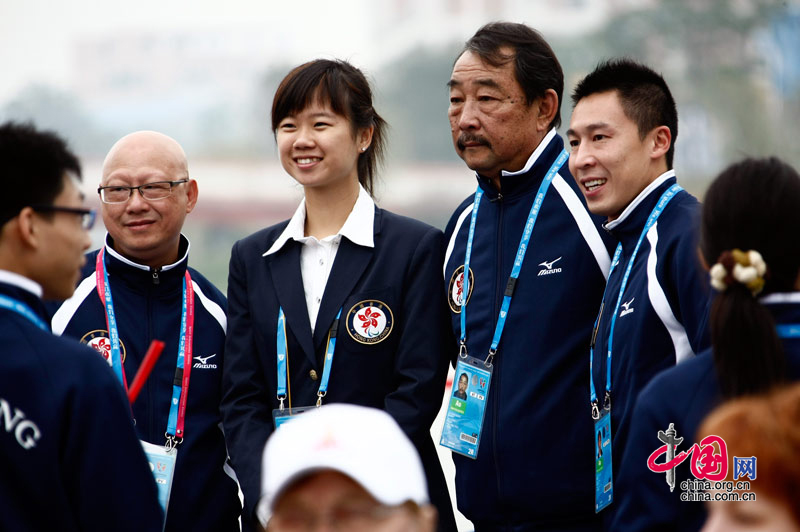 Members of China's Hong Kong delegation attend the national flag raising ceremony at the Athletes' Village of the Guangzhou 2010 Asian Para Games in Guangzhou, capital of south China's Guangdong Province, Dec. 11, 2010. [Zhao Na/ China.org.cn]