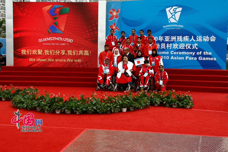 Members of the Bahrain delegation take pictures together after attending the national flag raising ceremony at the Athletes' Village of the Guangzhou 2010 Asian Para Games in Guangzhou, capital of south China's Guangdong Province, Dec. 11, 2010. [Zhao Na/ China.org.cn] 