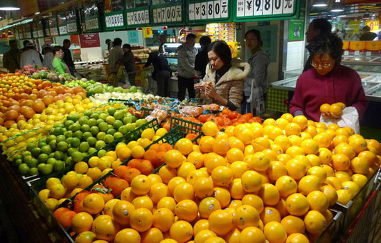 Customers choose fruits at a supermarket in Shanghai, on Saturday Dec 11, 2010. 