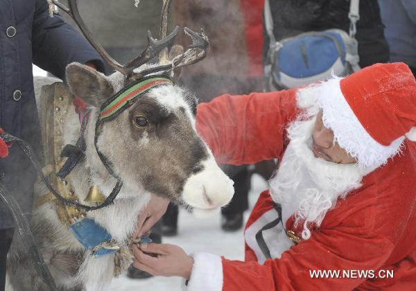 A local hunter dressed as Santa Claus prepares his sledge at the opening ceremony of the Genhe snow festival in Genhe, north China&apos;s Inner Mongolia Autonomous Region, Dec. 12, 2010. The annual snow festival kicked off here Sunday as temperature in Genhe hit as low as minus 45 degrees Celsius. [Xinhua]