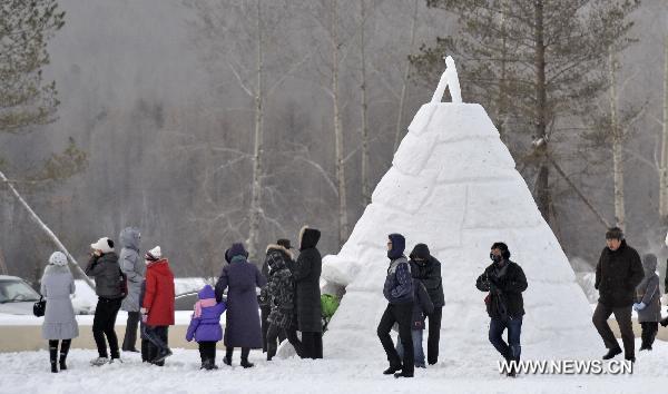 People are seen in the snow in Genhe, north China&apos;s Inner Mongolia Autonomous Region, Dec. 12, 2010. Temperature in Genhe hit as low as minus 45 degrees Celsius on Sunday, according to local meteorological authorities. A sharp temperature drop of more than ten degrees Celsius, caused by recent cold snaps, was recorded in the Inner Mongolian city. [Xinhua]