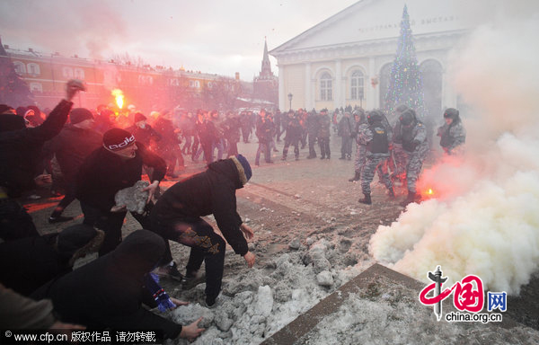 Protesters burn smoke grenades as they gathered in central Moscow&apos;s Manege Square to remember a Spartak fan, Yegor Sviridov, who was killed a few days earlier in Moscow by several men from Russia&apos;s Caucasus region. [CFP]