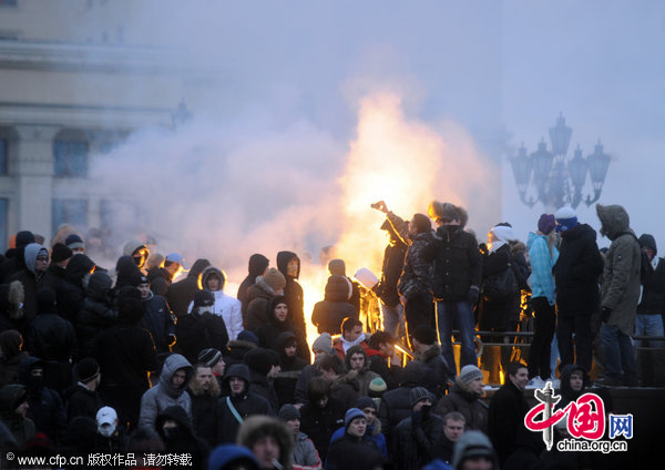 Protesters burn smoke grenades as they gathered in central Moscow&apos;s Manege Square to remember a Spartak fan, Yegor Sviridov, who was killed a few days earlier in Moscow by several men from Russia&apos;s Caucasus region. [CFP]