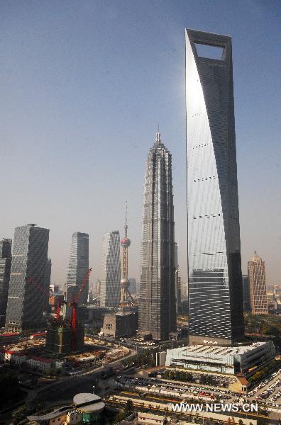 The construction site of Shanghai Tower (L, bottom) is seen in Pudong District of Shanghai, east China, Dec. 8, 2010.