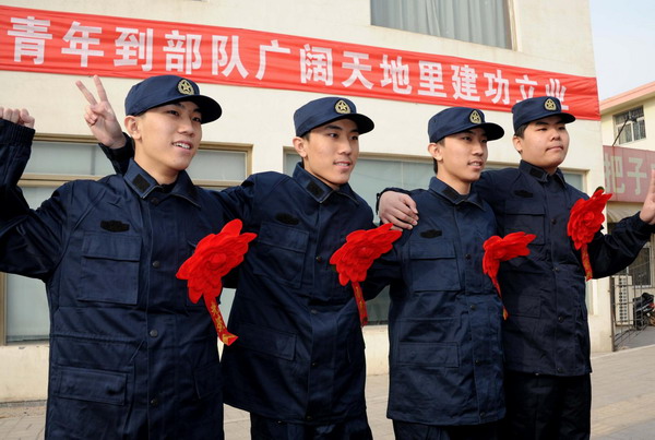 Quadruplets, from left, Sun Changtao, Sun Changling, Sun Changfeng, Sun Changyu, pose for a photo after being recruited by the conscription office of Shizhong distrcit in Jinan, East China's Shandong province, Dec 12, 2010. The quadruplets, born in February 1992, have been receiving public assistance and attention. [Photo/Xinhua] 